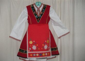 Първокласничка облича носия за първия учебен ден