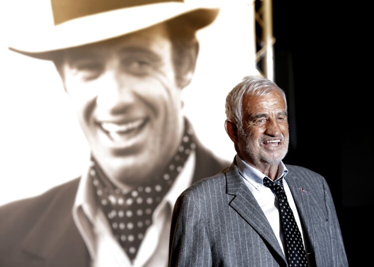 FILE - In this Oct. 14, 2013 file photo, French actor Jean-Paul Belmondo poses for photographers as he arrives at the opening ceremony of the 5th edition of the Lumiere Festival, in Lyon, central France. French New Wave actor Jean-Paul Belmondo has died, according to his lawyer’s office on Monday Sept. 6, 2021. (AP Photo/Laurent Cipriani, File)