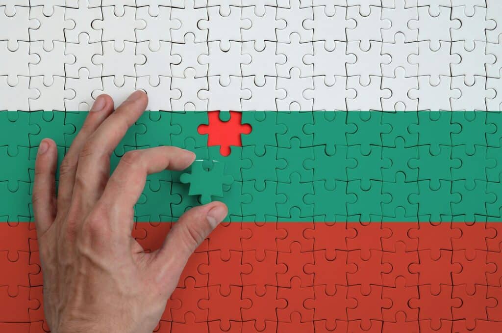 bulgaria flag is depicted on a puzzle which the man s hand completes to fold