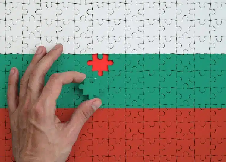 bulgaria flag is depicted on a puzzle which the man s hand completes to fold