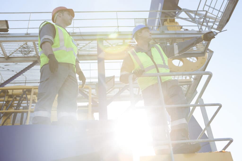 construction workers talking on sunny industrial s 2026 03 09 04 55 48 utc scaled 1