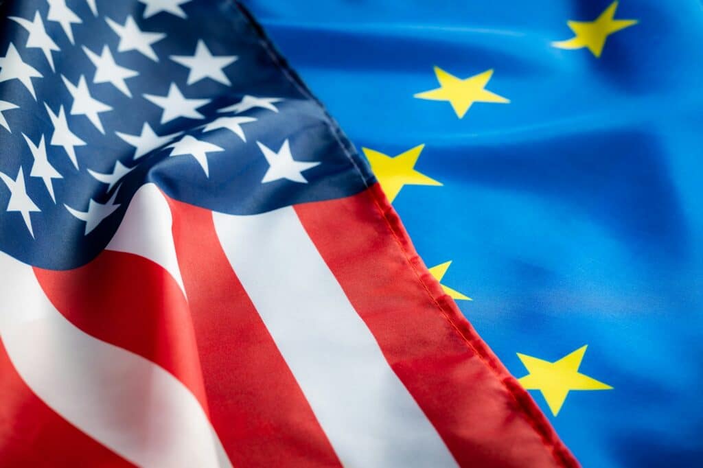 eu europe union flag and usa united states of america flag two waving flags