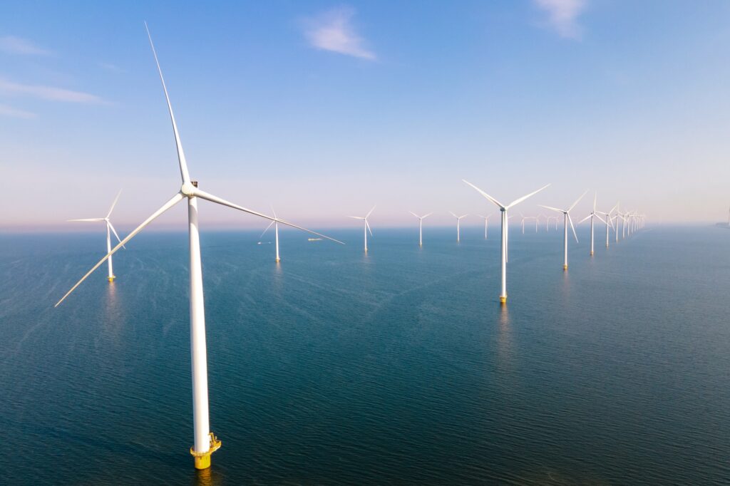 offshore windmill park with clouds and a blue sky