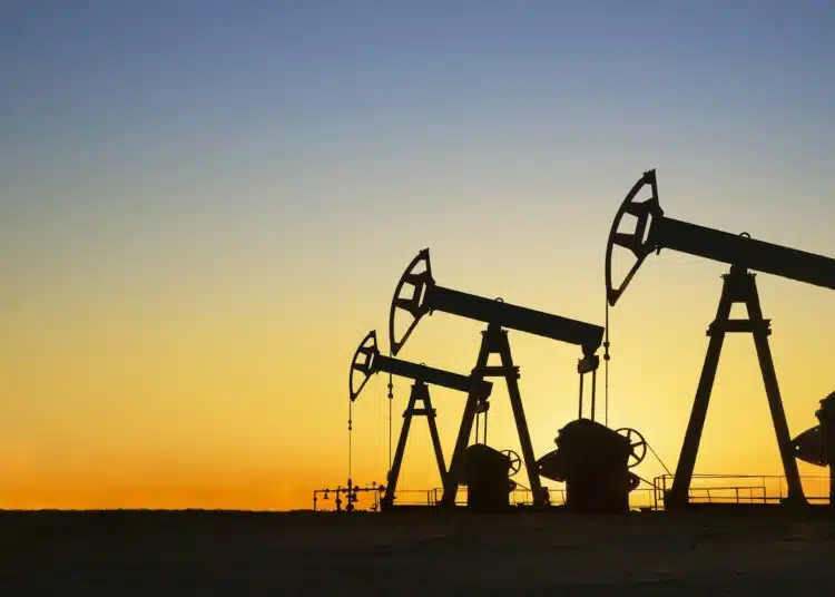 silhouette of oil wells in desert at sunset texas usa
