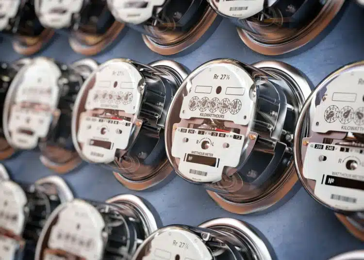 electric meters in a row measuring power use electricity consum