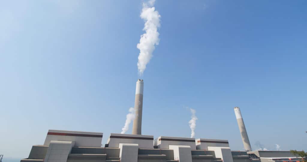 smoke from chimney in factory over blue sky 2026 03 24 23 04 26 utc scaled 1
