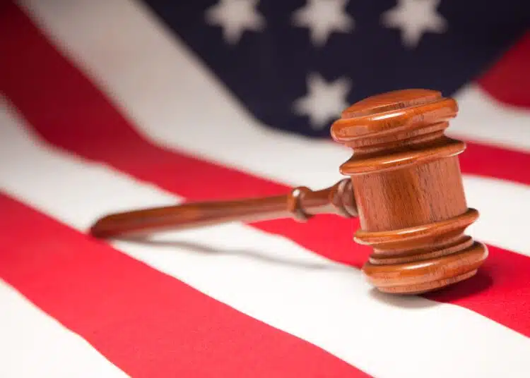 justice gavel resting on an american flag