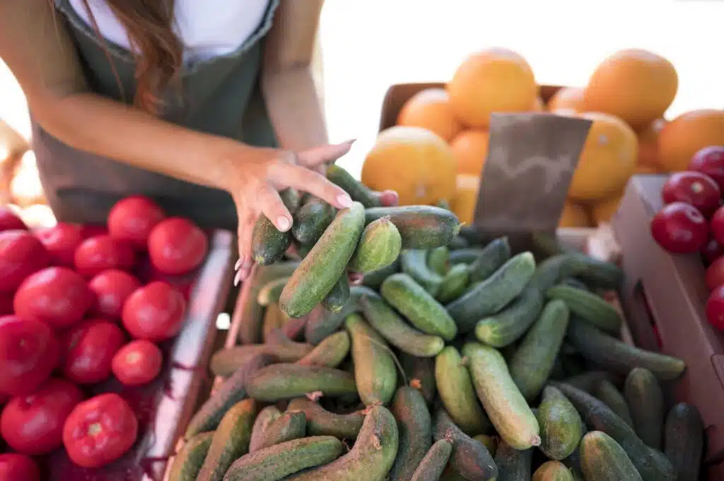 woman taking bunch cucumbers 2cde2f07